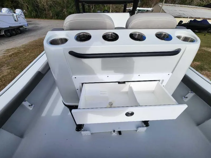 Slide: The Image of 2025 Caymas 281 HB boat interior with storage drawer and cup holders. - 24