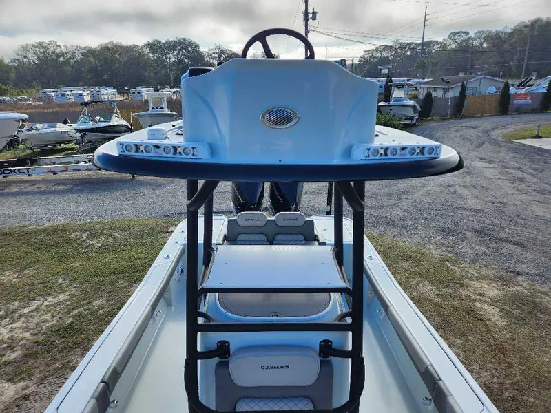 Slide: The Image of 2025 Caymas 281 HB boat, view of helm and seating, parked outdoors. - 4
