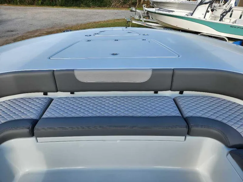 Slide: The Image of 2025 Caymas 281 HB boat interior with cushioned seating and storage compartments. - 5