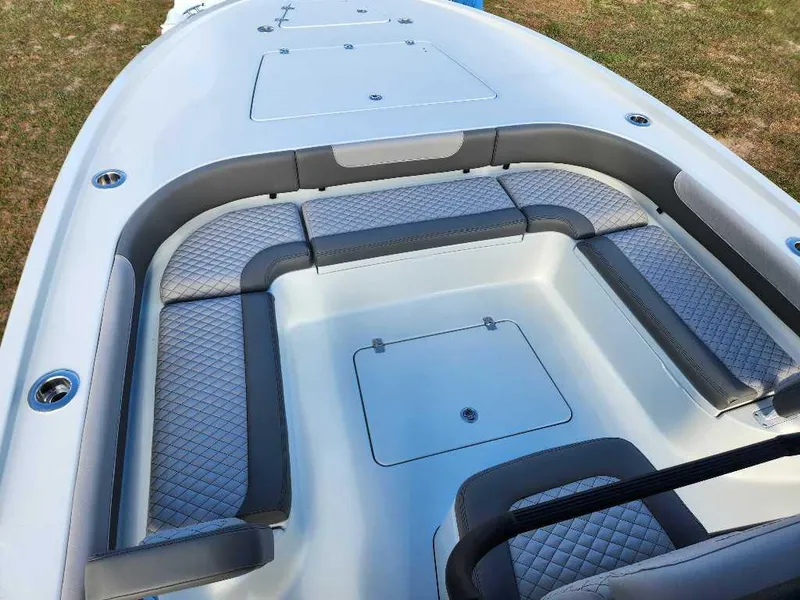 Slide: The Image of 2025 Caymas 281 HB boat interior with cushioned seating and storage compartments. - 6