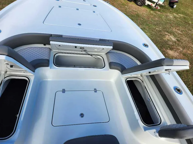 Slide: The Image of 2025 Caymas 281 HB boat interior with open storage compartments and cushioned seating. - 8