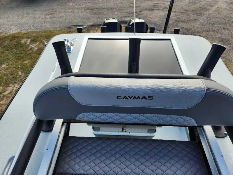 Slide: The Image of 2025 Caymas 281 HB boat interior with cushioned seating and rod holders. - 9