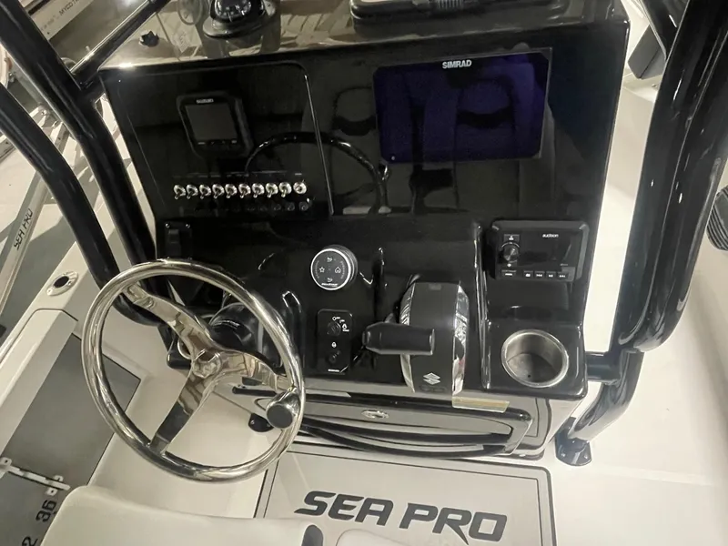 Slide: The Image of 2025 Sea Pro 230 Bay boat dashboard with steering wheel and controls. - 10