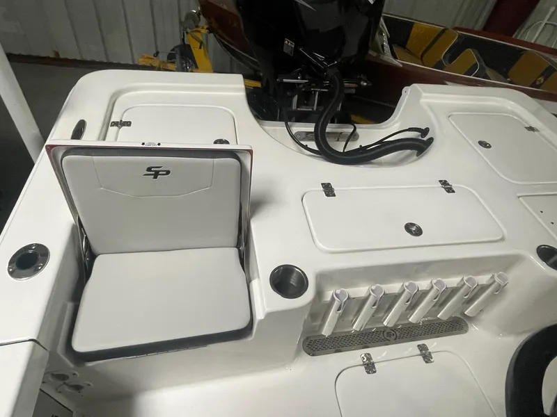 Slide: The Image of 2025 Sea Pro 230 Bay boat deck with storage compartments and rod holders. - 11