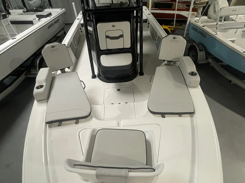 Slide: The Image of 2025 Sea Pro 230 Bay boat interior with cushioned seating and console. - 2