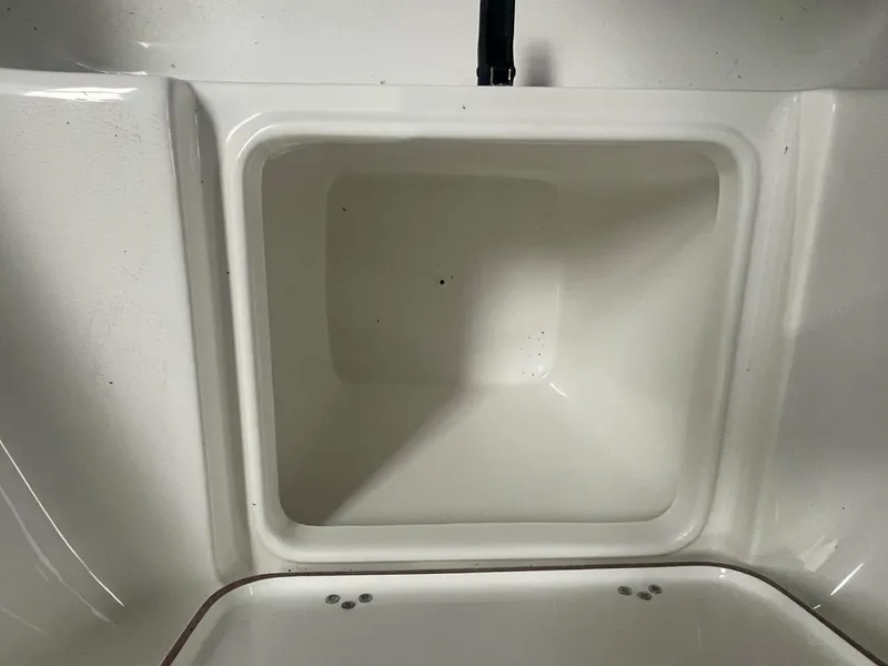 Slide: The Image of Interior compartment of 2025 Sea Pro 230 Bay boat, featuring a clean, white finish. - 5