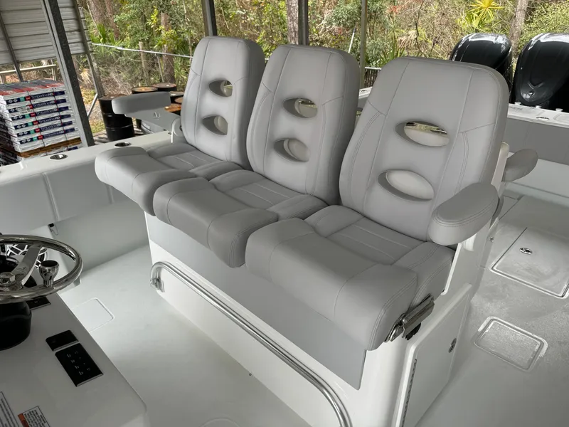 Slide: The Image of 2026 Contender 39 ST boat with three gray cushioned seats in the cockpit area. - 14