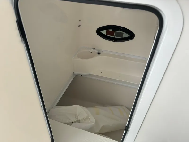 Slide: The Image of Interior cabin of 2026 Contender 39 ST boat with small window and storage space. - 16