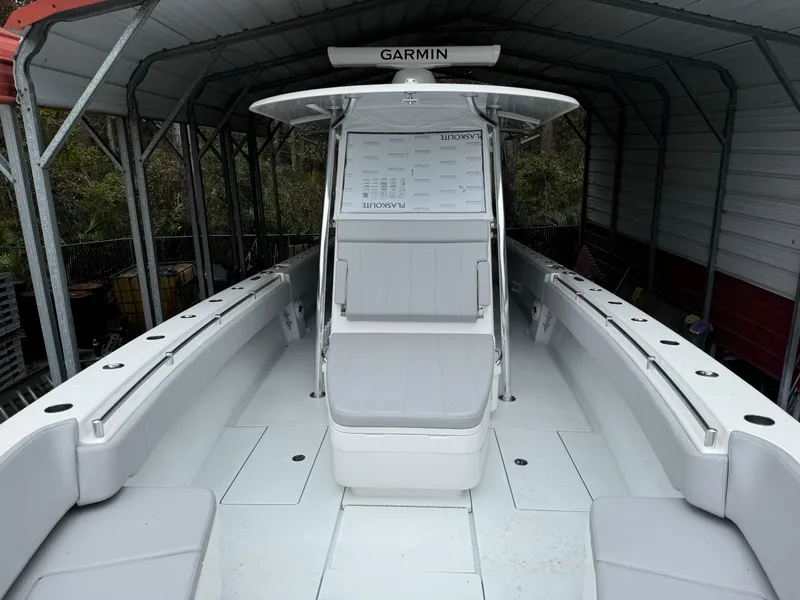 Slide: The Image of 2026 Contender 39 ST boat interior with Garmin navigation system under a shelter. - 18