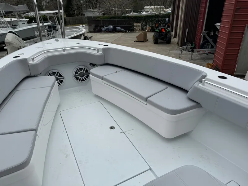 Slide: The Image of 2026 Contender 39 ST boat interior with gray seating and storage compartments. - 19