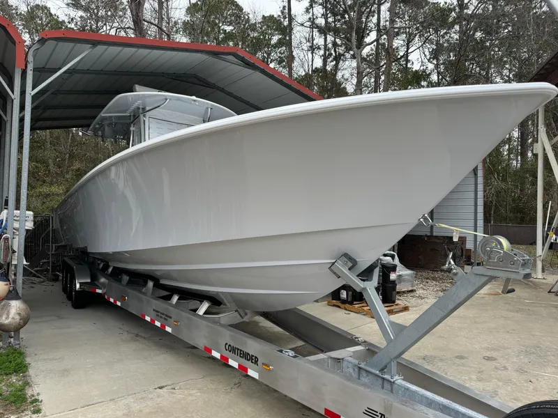 Slide: The Image of 2026 Contender 39 ST boat on trailer under shelter, ready for transport. - 2