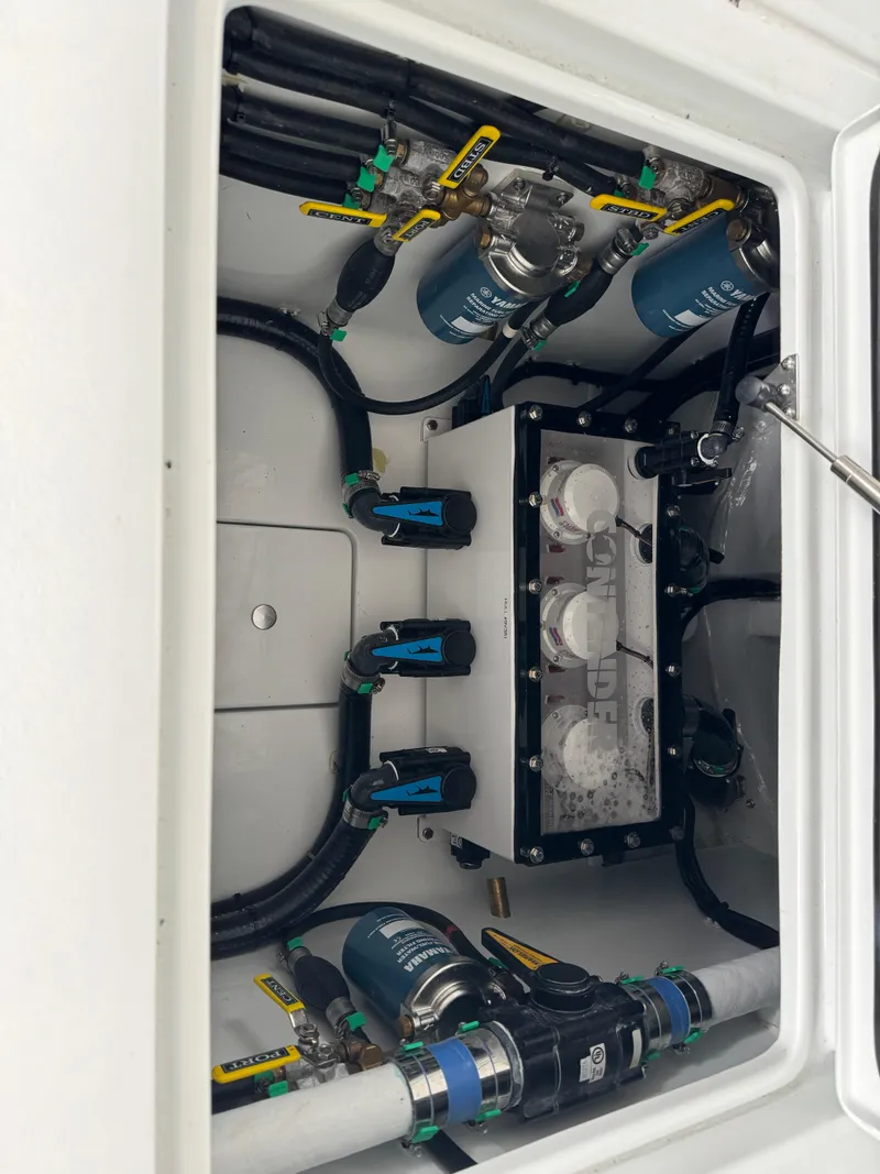 Slide: The Image of 2026 Contender 39 ST boat engine compartment with fuel filters and hoses. - 24