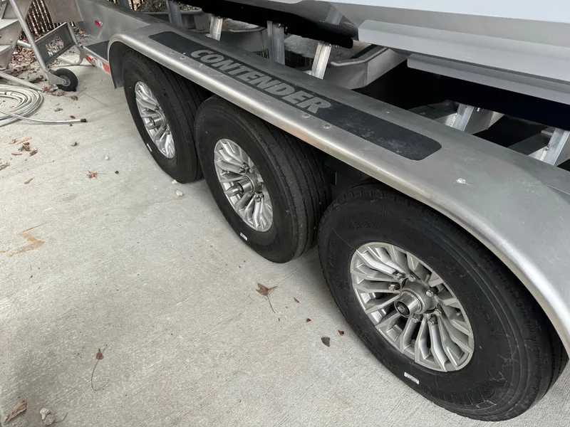 Slide: The Image of Triple-axle trailer for 2026 Contender 39 ST boat, featuring durable wheels. - 26