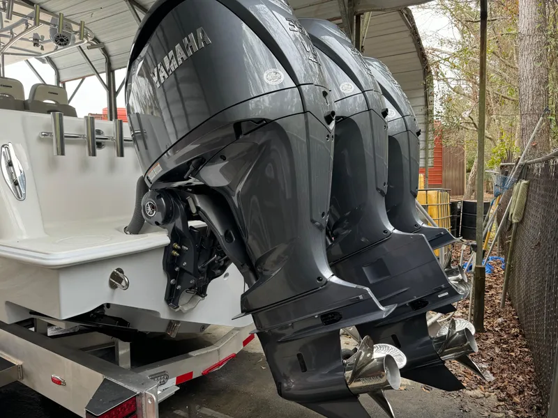 Slide: The Image of 2026 Contender 39 ST boat with Yamaha outboard motors in a covered area. - 28