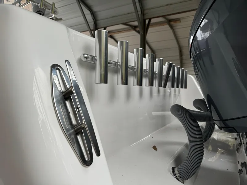 Slide: The Image of 2026 Contender 39 ST boat with rod holders and cleat in a covered storage area. - 29