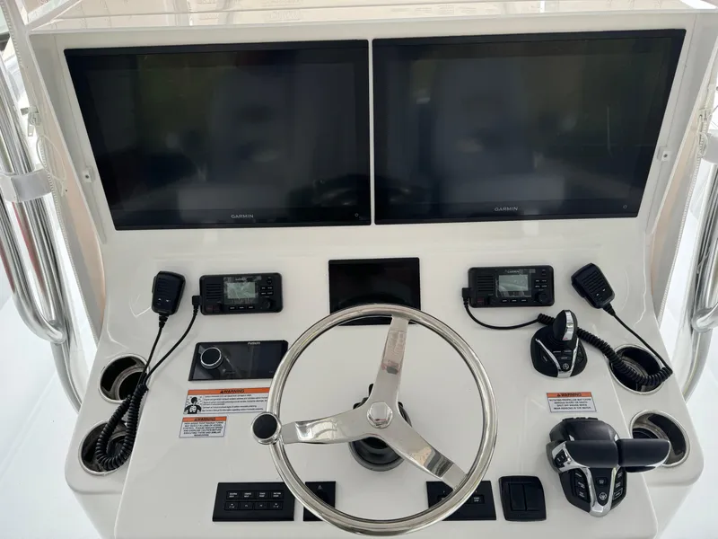 Slide: The Image of Helm of 2026 Contender 39 ST boat with dual screens and controls. - 5