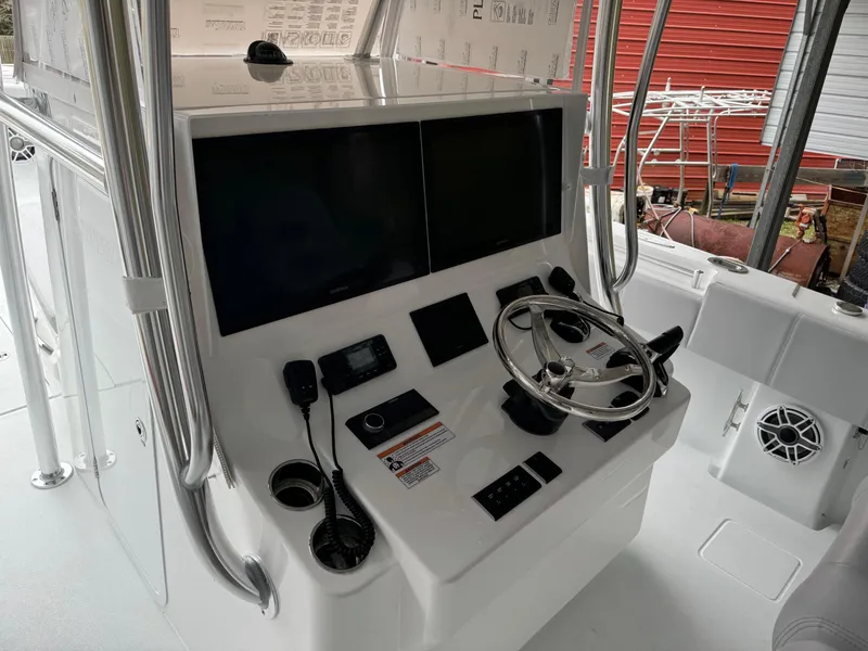 Slide: The Image of 2026 Contender 39 ST boat console with steering wheel and electronic displays. - 6