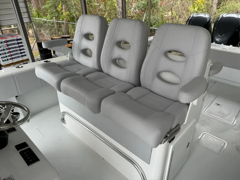 Slide: The Image of 2026 Contender 39 ST boat with three gray cushioned seats in the cockpit area. - 7