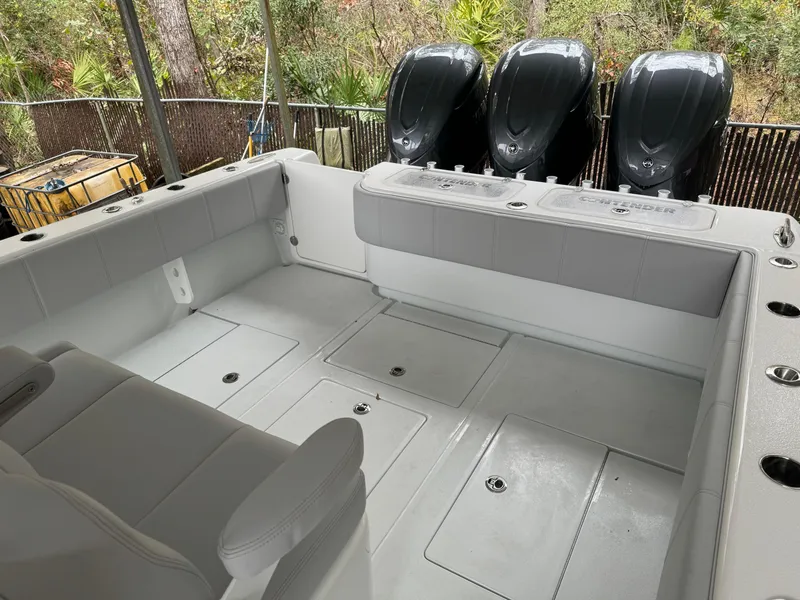 Slide: The Image of 2026 Contender 39 ST boat interior with triple outboard engines, spacious seating, and storage compartments. - 15