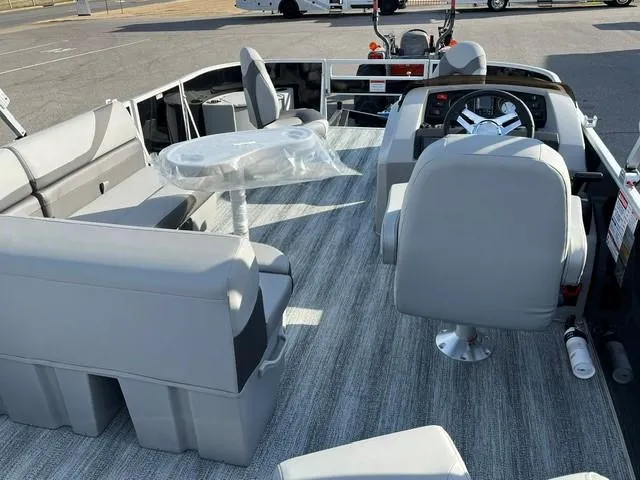 Slide: The Image of 2025 Bennington 18 SXFSE boat interior with gray seating and steering console. - 5