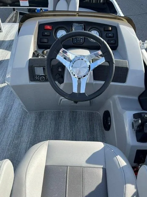 Slide: The Image of 2025 Bennington 18 SXFSE boat dashboard with steering wheel and controls. - 6