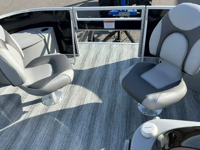 Slide: The Image of 2025 Bennington 18 SXFSE boat interior with gray seating and carpeted flooring. - 7