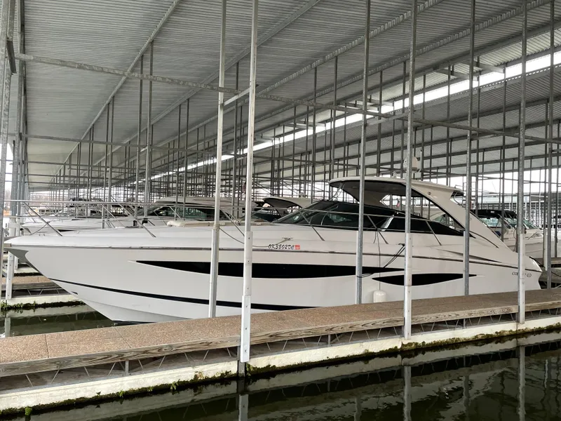 Slide: The Image of 2008 Cobalt 46 yacht docked in a covered marina. - 0