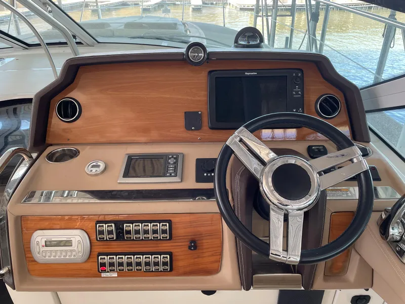 Slide: The Image of Helm of 2008 Cobalt 46 yacht with steering wheel and navigation controls. - 10