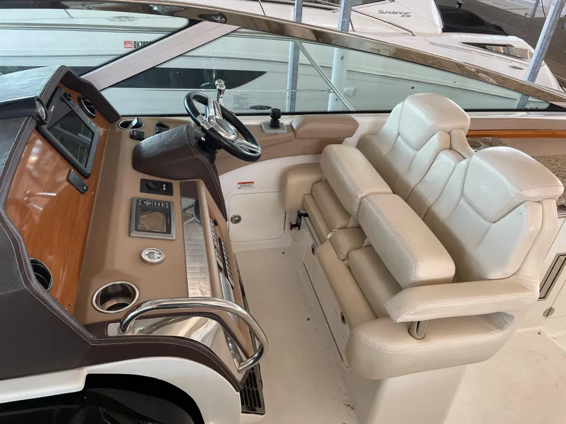Slide: The Image of Helm of 2008 Cobalt 46 yacht with dual white leather seats and modern controls. - 12