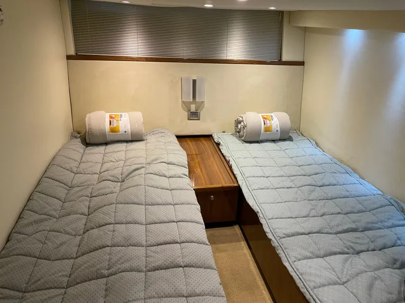 Slide: The Image of Interior cabin of 2008 Cobalt 46 yacht with twin beds and cozy bedding. - 14