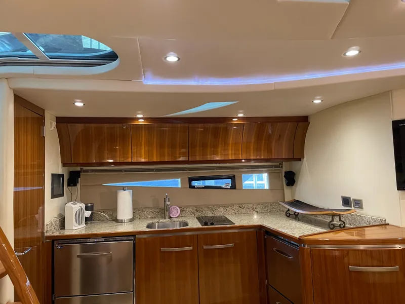 Slide: The Image of Luxurious kitchen interior of 2008 Cobalt 46 yacht with modern amenities and wood finish. - 15