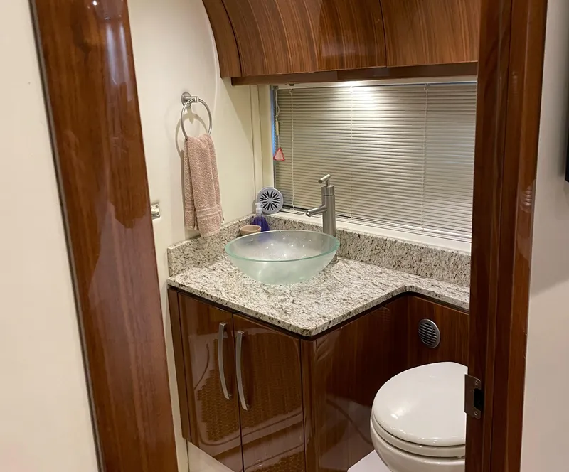 Slide: The Image of Luxurious bathroom in 2008 Cobalt 46 yacht with modern sink and wooden cabinetry. - 20