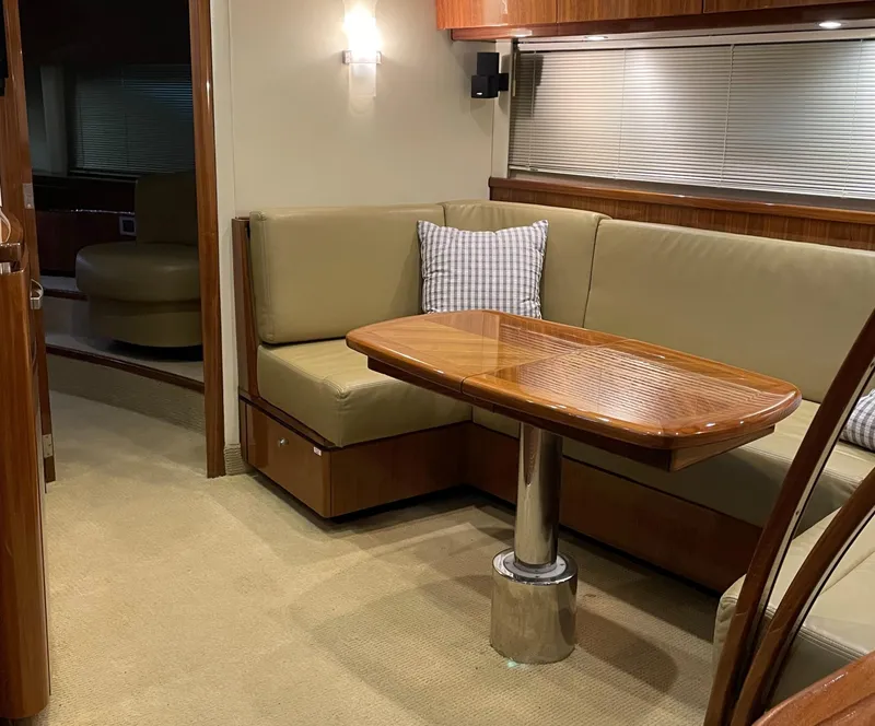 Slide: The Image of Interior of 2008 Cobalt 46 yacht with beige seating and wooden table. - 21