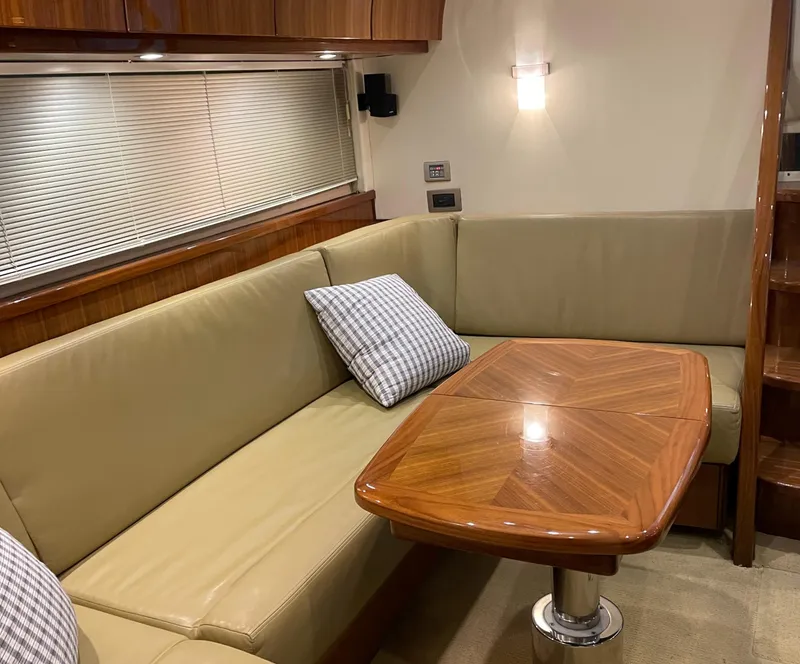 Slide: The Image of Interior of 2008 Cobalt 46 yacht with leather seating and wooden table. - 23
