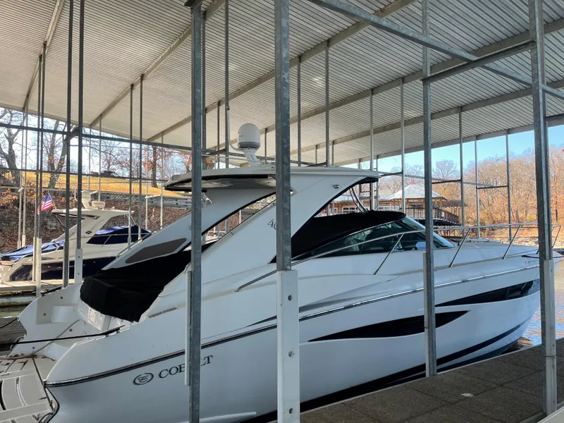Slide: The Image of 2008 Cobalt 46 yacht docked in a covered marina, side view. - 3