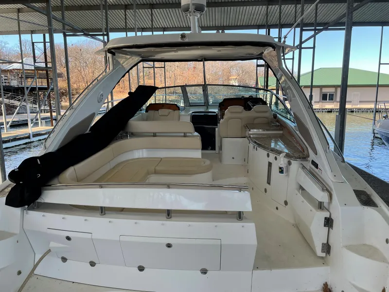 Slide: The Image of 2008 Cobalt 46 yacht with spacious seating, docked under a covered marina. - 4