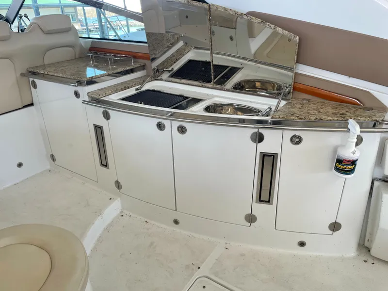 Slide: The Image of 2008 Cobalt 46 yacht interior with kitchenette, featuring granite countertops and stainless steel sink. - 7