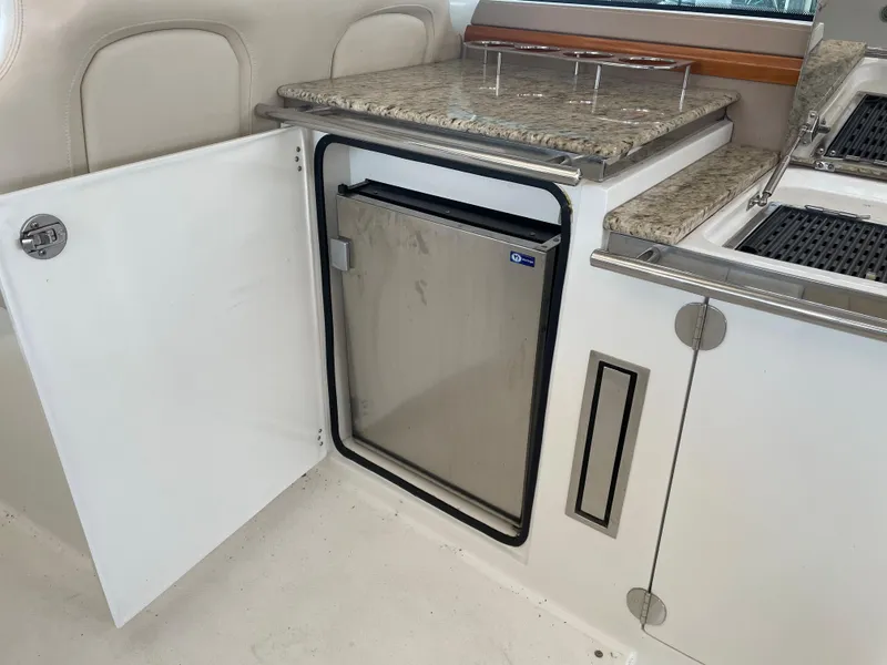 Slide: The Image of 2008 Cobalt 46 yacht interior with open cabinet and stainless steel mini fridge. - 8