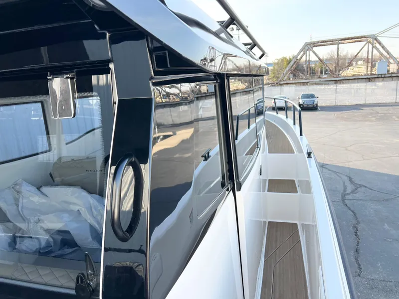 Slide: The Image of 2025 Navan C30 boat with sleek design, docked near industrial area. - 11