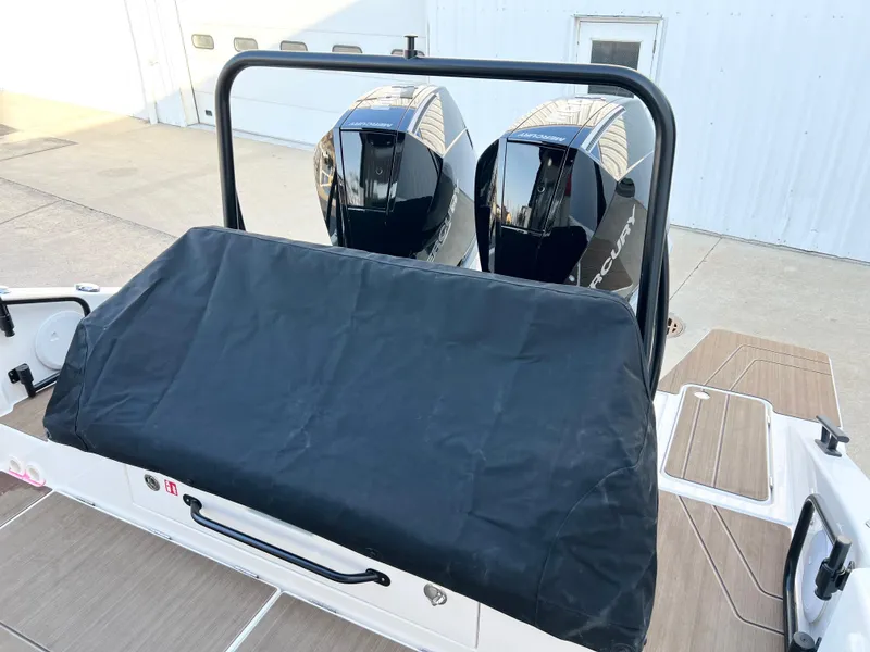 Slide: The Image of 2025 Navan C30 boat with dual outboard engines, covered seating, and wooden deck. - 12