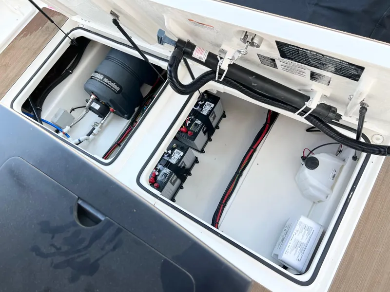 Slide: The Image of Open engine compartment of 2025 Navan C30 with visible batteries and wiring. - 15