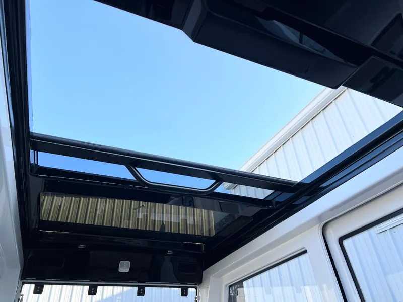 Slide: The Image of Sunroof view of 2025 Navan C30, showcasing sleek design and clear blue sky. - 24