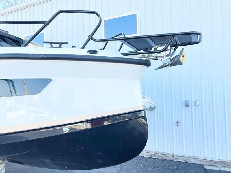 Slide: The Image of Navan C30 2025 boat bow with anchor, docked near a white building. - 4