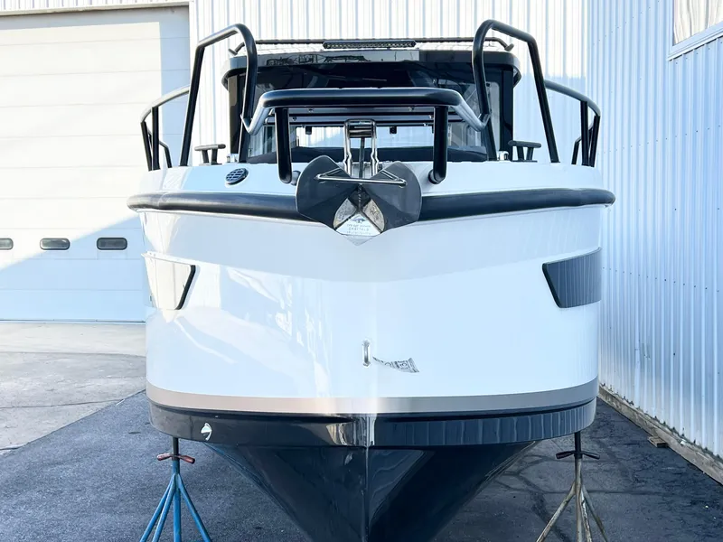 Slide: The Image of 2025 Navan C30 boat front view, docked outdoors near a building. - 5