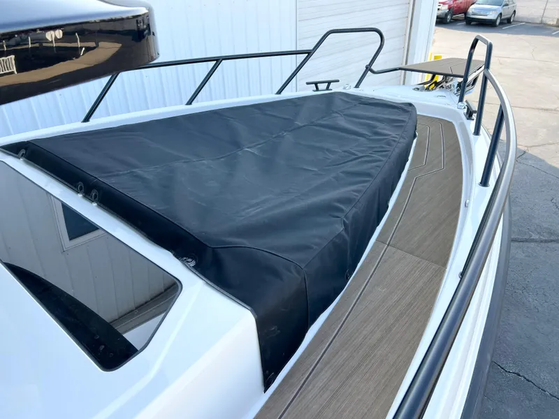 Slide: The Image of Navan C30 2025 boat with black cover on deck, docked outdoors. - 7