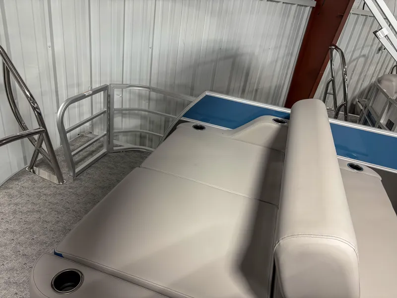 Slide: The Image of 2025 Trifecta 24 UL LE pontoon boat interior with beige seating and blue accents. - 10