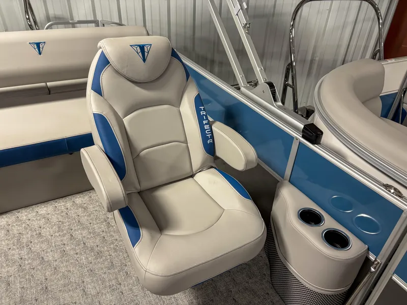 Slide: The Image of 2025 Trifecta 24 UL LE boat interior with blue and gray seating and cup holders. - 5