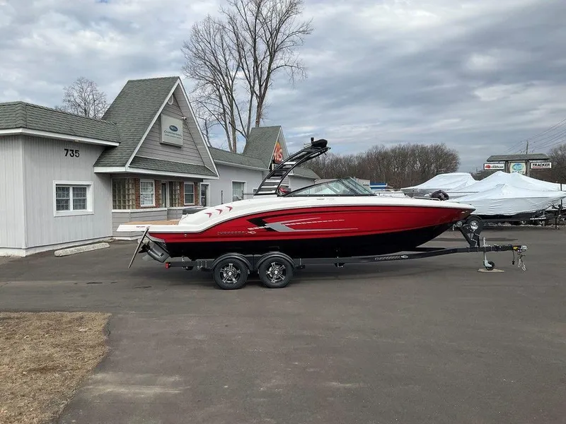 The Image of 2025 Chaparral 23 SSi boat on trailer, parked outside a building. - 0