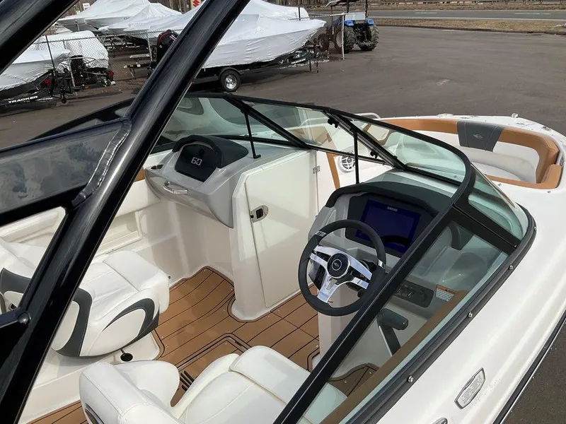 Slide: The Image of 2025 Chaparral 23 SSi boat interior with modern dashboard and seating. - 1