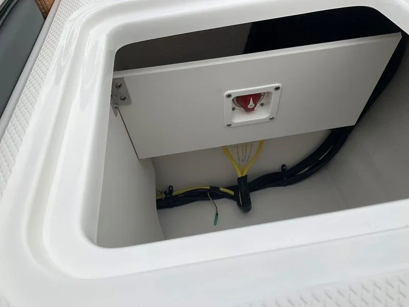 Slide: The Image of 2025 Chaparral 23 SSi boat storage compartment with wiring and switch. - 11